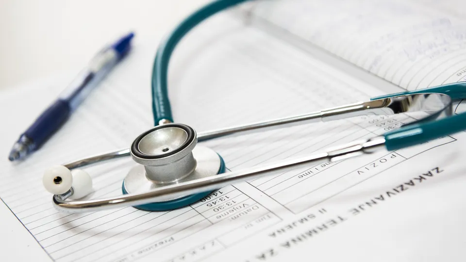 Insurance documents and medical notes on a desk